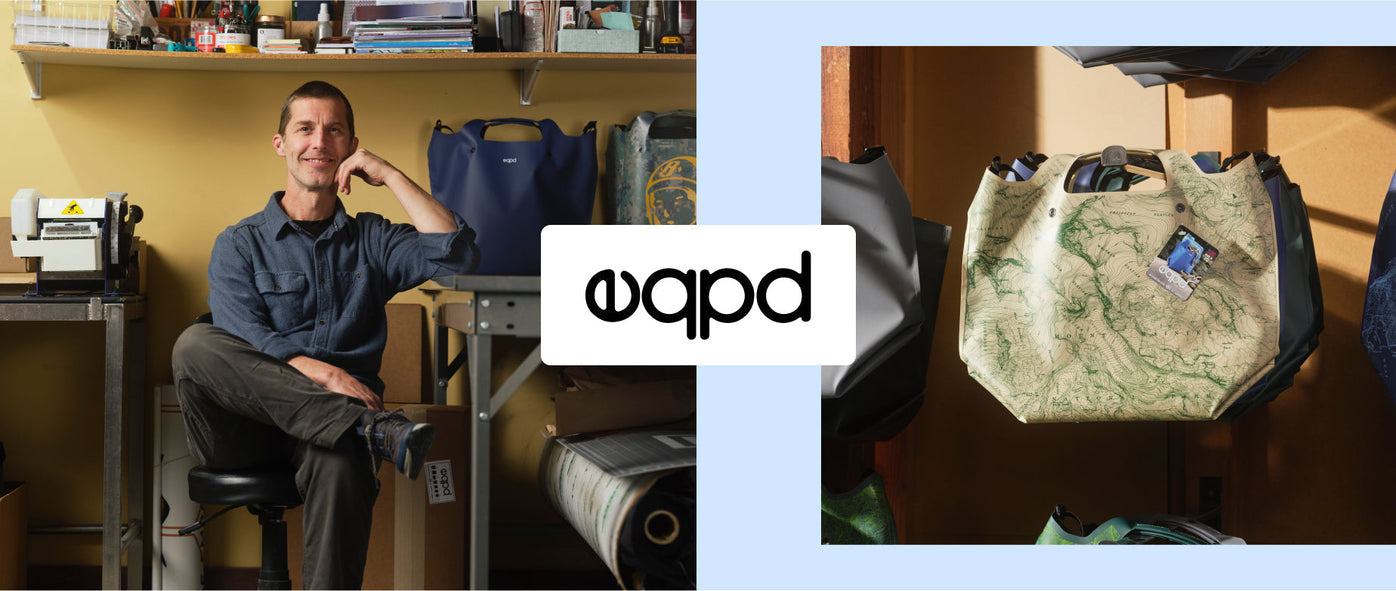 Two images separated by an epqd logo. On the left, the eqpd founder is sitting in a workshop wearing a blue shirt and dark pants. His arm is resting on the table where two eqpd bags sit on the table. On the right, eqpd bags hang on metal racks.